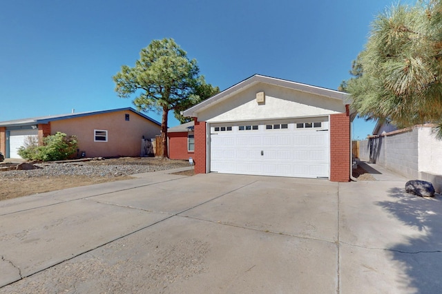 6625 Barnhart St NE, Albuquerque, NM 87109 - view of side of property with a garage, driveway, and brick siding