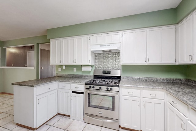 6625 Barnhart St NE, Albuquerque, NM 87109 - kitchen with a peninsula, light tile patterned flooring, under cabinet range hood, white cabinets, and stainless steel range with gas stovetop