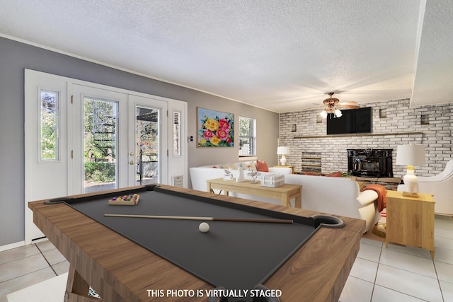 4719 Huntington Dr NE, Albuquerque, NM 87111 - rec room featuring a brick fireplace, light tile patterned floors, pool table, a ceiling fan, and a textured ceiling