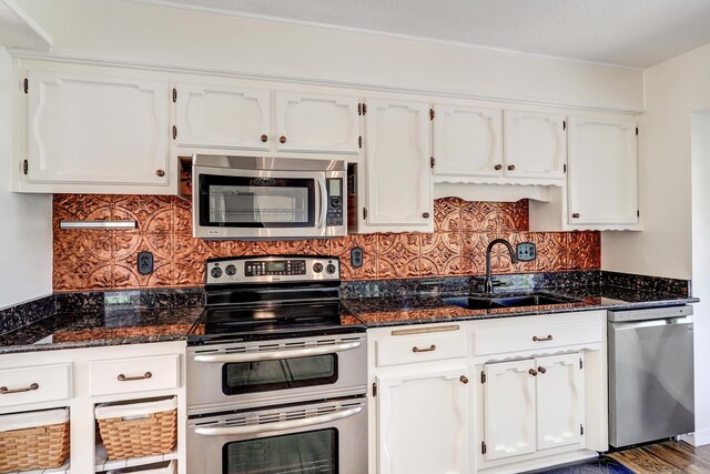 4719 Huntington Dr NE, Albuquerque, NM 87111 - kitchen with appliances with stainless steel finishes, white cabinets, and tasteful backsplash