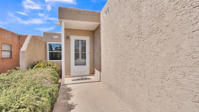 11119 Sidney Ave NE, Albuquerque, NM 87111 - view of exterior entry with visible vents and stucco siding