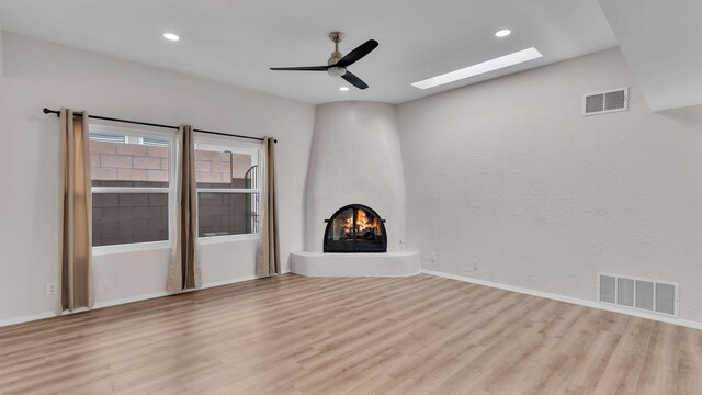 11119 Sidney Ave NE, Albuquerque, NM 87111 - unfurnished living room with visible vents, wood finished floors, and a skylight