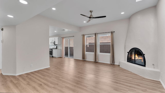 11119 Sidney Ave NE, Albuquerque, NM 87111 - unfurnished living room featuring recessed lighting, ceiling fan, a large fireplace, and light wood-style flooring