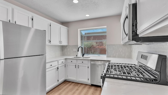 11119 Sidney Ave NE, Albuquerque, NM 87111 - kitchen featuring a sink, white cabinetry, and appliances with stainless steel finishes