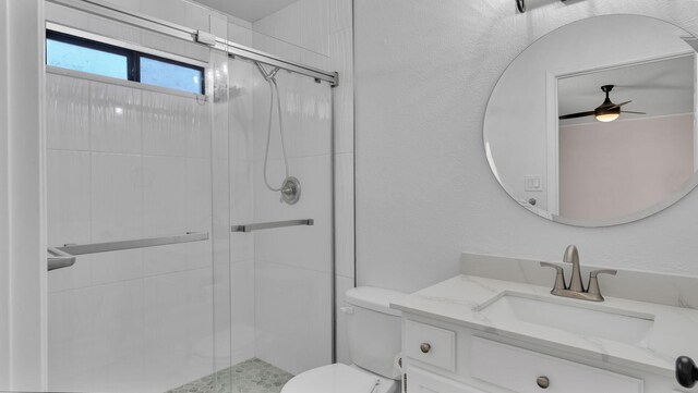 11119 Sidney Ave NE, Albuquerque, NM 87111 - bathroom featuring vanity, toilet, ceiling fan, and a stall shower