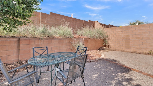 11119 Sidney Ave NE, Albuquerque, NM 87111 - view of patio featuring outdoor dining area and a fenced backyard