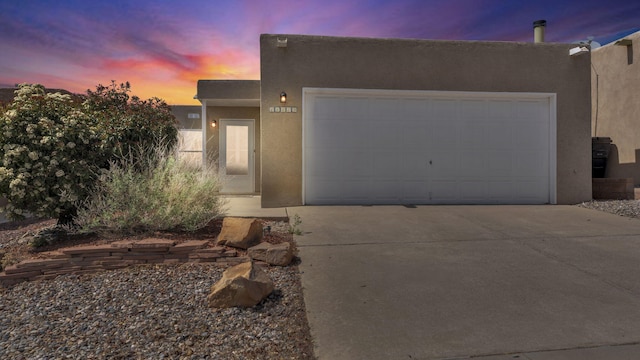 11119 Sidney Ave NE, Albuquerque, NM 87111 - adobe home featuring an attached garage, stucco siding, and driveway