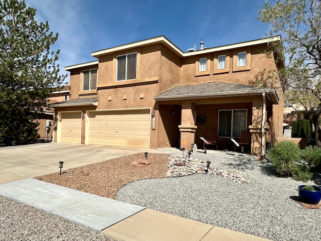 view of front of property with a porch, an attached garage, stucco siding, and driveway
