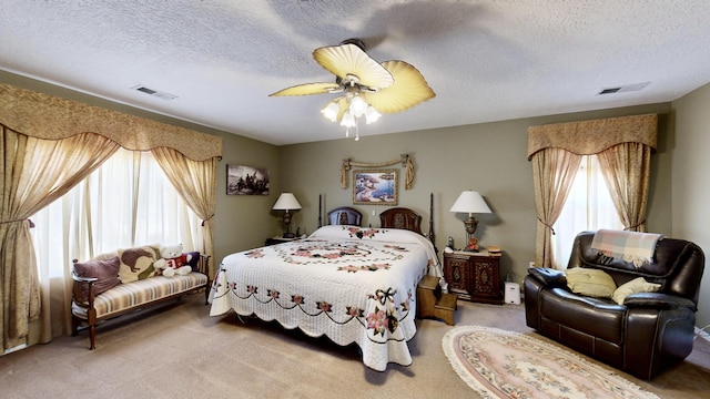 bedroom featuring light carpet, visible vents, and multiple windows