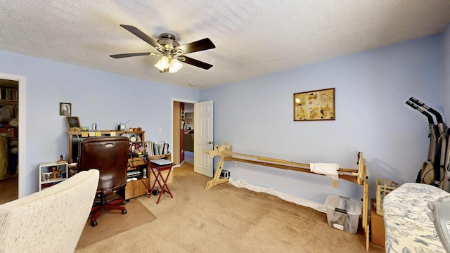carpeted bedroom with a textured ceiling and a ceiling fan
