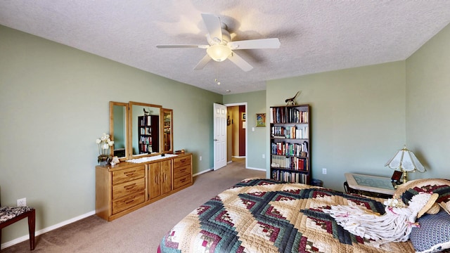 bedroom with light colored carpet, a textured ceiling, and baseboards