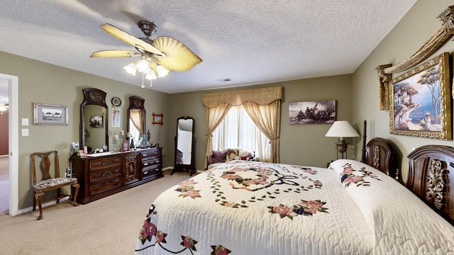 carpeted bedroom featuring ceiling fan, a textured ceiling, baseboards, and visible vents
