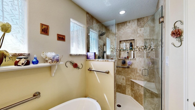 bathroom featuring a stall shower and a freestanding tub