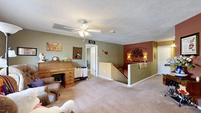 carpeted living room featuring a textured ceiling, visible vents, baseboards, and ceiling fan