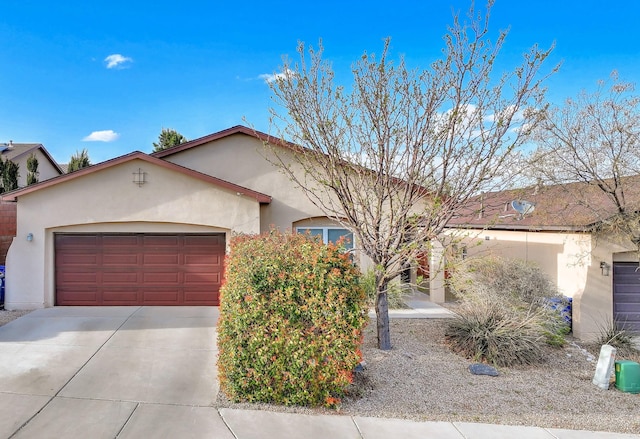 5679 Cold Creek Ave NW, Albuquerque, NM 87114 - view of front of property featuring stucco siding, an attached garage, and driveway