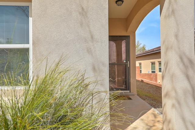5679 Cold Creek Ave NW, Albuquerque, NM 87114 - view of exterior entry with fence and stucco siding