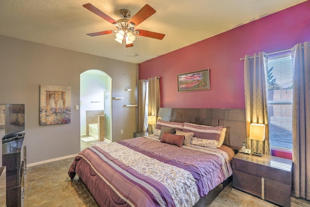 5679 Cold Creek Ave NW, Albuquerque, NM 87114 - bedroom featuring connected bathroom, arched walkways, and ceiling fan