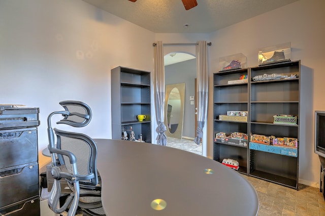 5679 Cold Creek Ave NW, Albuquerque, NM 87114 - office featuring arched walkways, a ceiling fan, and stone finish flooring