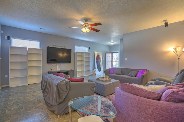 5679 Cold Creek Ave NW, Albuquerque, NM 87114 - living area featuring a ceiling fan, a textured ceiling, and a wealth of natural light