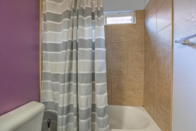 5679 Cold Creek Ave NW, Albuquerque, NM 87114 - full bathroom with a textured wall, shower / bath combo with shower curtain, and toilet