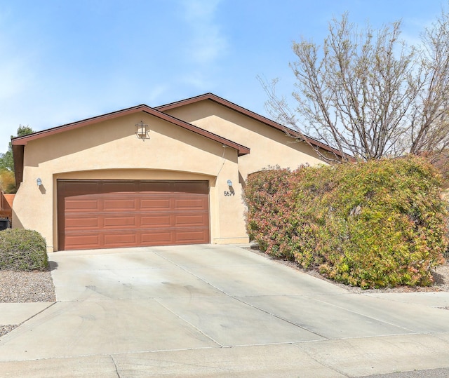 5679 Cold Creek Ave NW, Albuquerque, NM 87114 - mediterranean / spanish-style home with a garage, stucco siding, and driveway