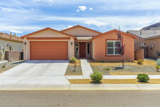590 Rio Chama Cir SW, Los Lunas, NM 87031 - ranch-style house featuring an attached garage, concrete driveway, and stucco siding