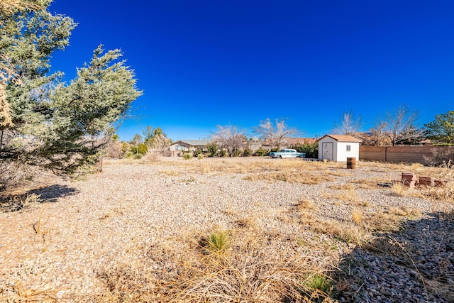 view of yard featuring an outbuilding and a storage shed