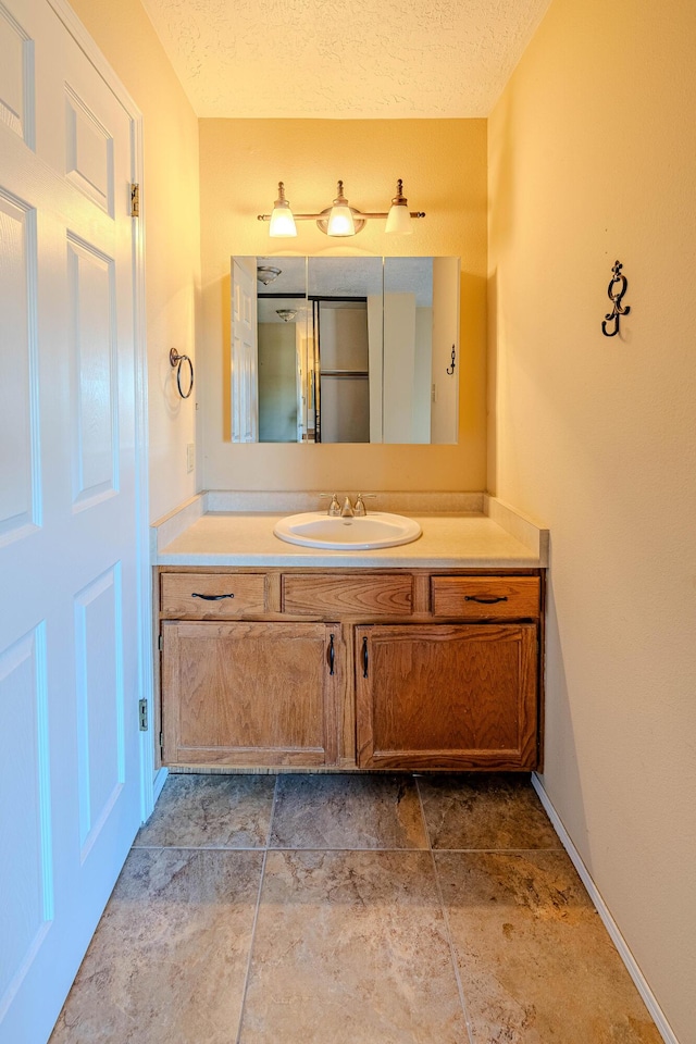 bathroom featuring vanity and a textured ceiling
