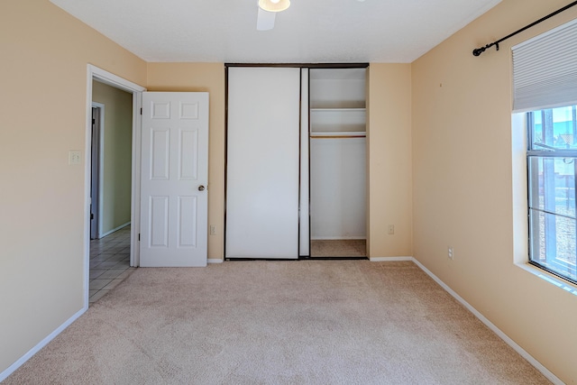 unfurnished bedroom featuring carpet floors, baseboards, and a closet