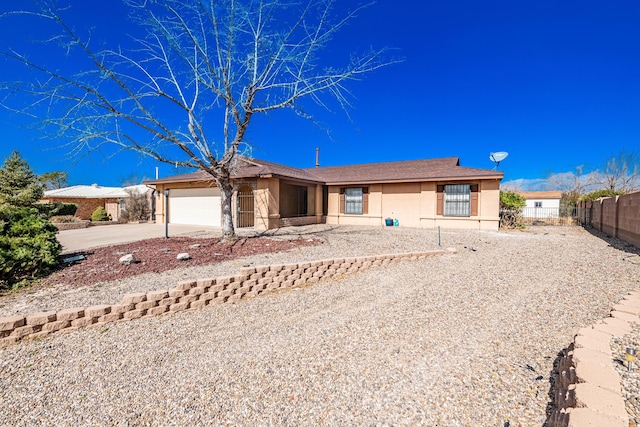single story home with fence, an attached garage, concrete driveway, and stucco siding