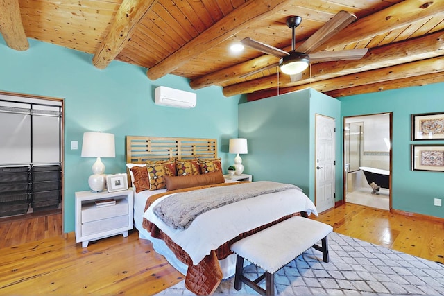 1316 Gabaldon Rd NW, Albuquerque, NM 87104 - bedroom featuring wood ceiling with exposed beams, a wall mounted AC, hardwood / wood-style floors, baseboards, and connected bathroom