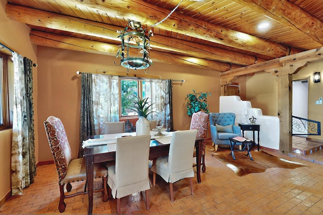 1316 Gabaldon Rd NW, Albuquerque, NM 87104 - dining space with brick flooring, wooden ceiling with exposed beams, washer / dryer, and baseboards
