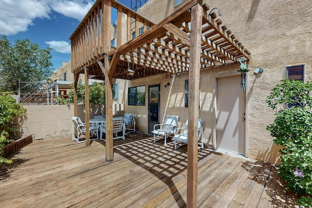 deck featuring a pergola, fence, and outdoor dining area
