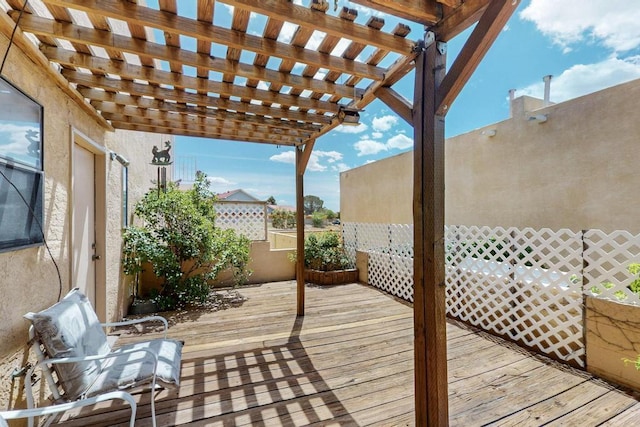 wooden terrace with fence and a pergola