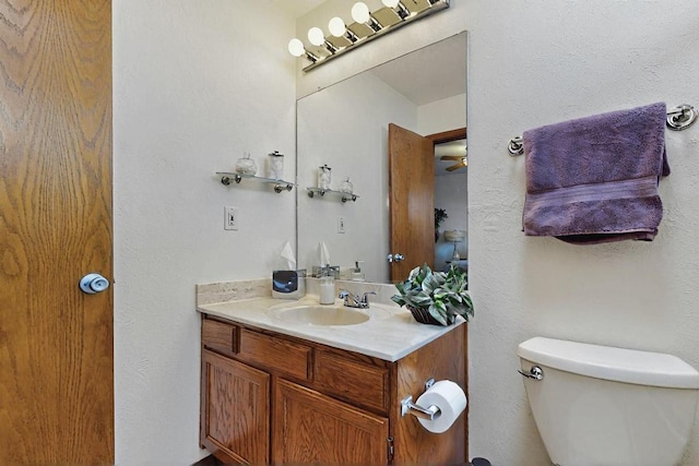 half bathroom featuring toilet and vanity