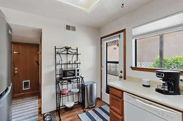 kitchen featuring visible vents, light countertops, light wood-style floors, and appliances with stainless steel finishes
