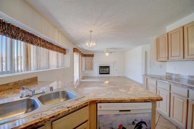 4312 Rancho Centro NW, Albuquerque, NM 87120 - kitchen with dishwasher, a sink, ceiling fan with notable chandelier, open floor plan, and a glass covered fireplace