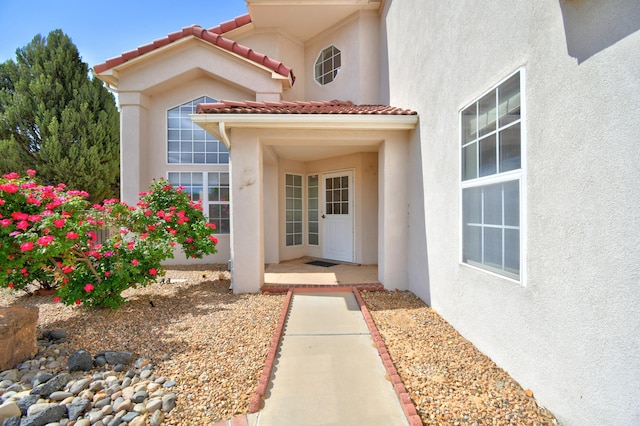 4312 Rancho Centro NW, Albuquerque, NM 87120 - doorway to property with stucco siding and a tiled roof