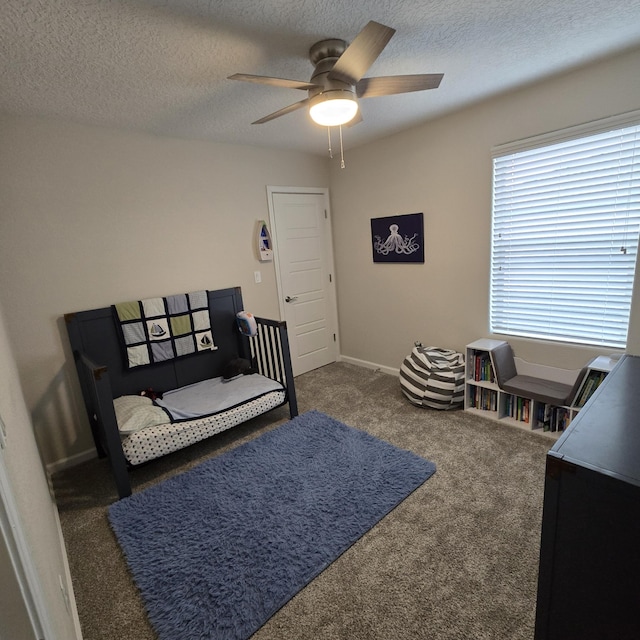 carpeted bedroom with baseboards, a ceiling fan, and a textured ceiling