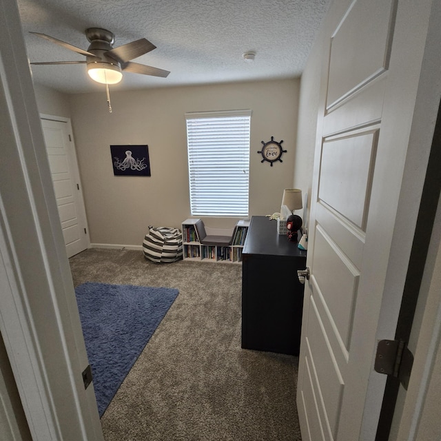 office area featuring baseboards, carpet, a ceiling fan, and a textured ceiling