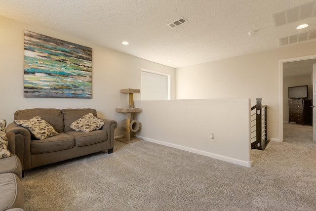 living room with visible vents, carpet, and baseboards