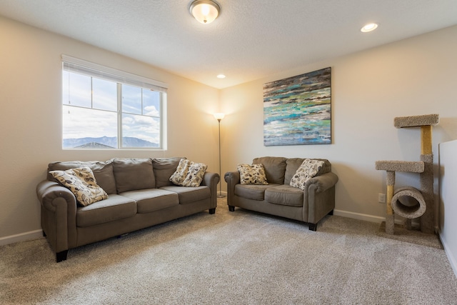 living area with baseboards, recessed lighting, and carpet
