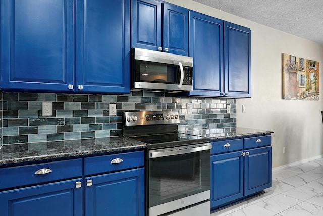 kitchen featuring marble finish floor, baseboards, blue cabinets, appliances with stainless steel finishes, and backsplash