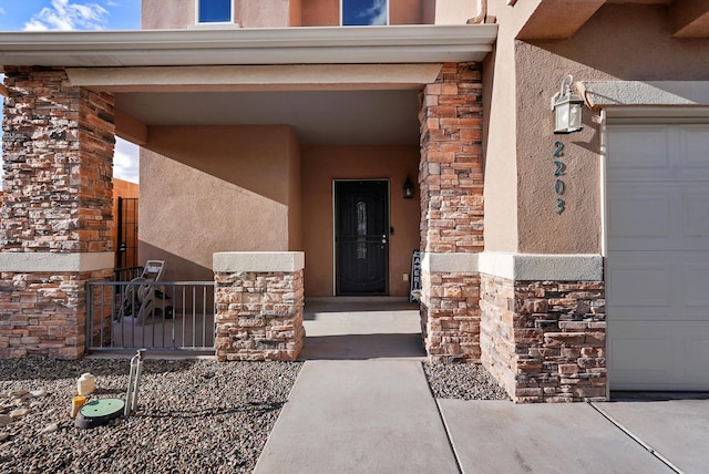 doorway to property featuring stucco siding and stone siding