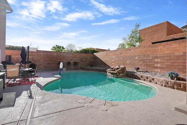 view of swimming pool with a fenced in pool, a fenced backyard, and a patio area