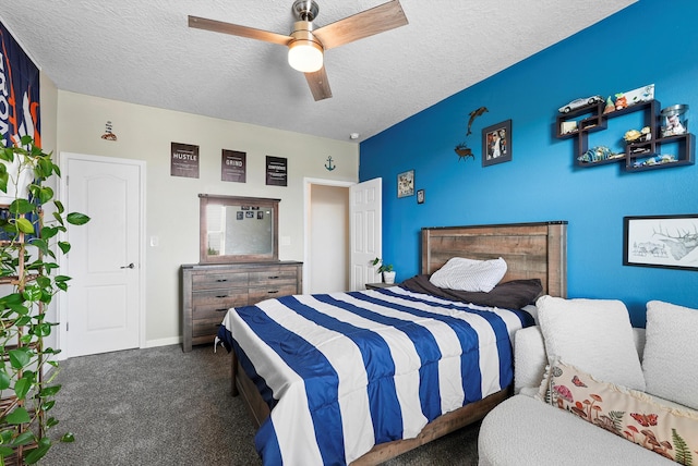 carpeted bedroom with a ceiling fan, a textured ceiling, and baseboards