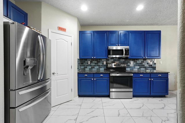 kitchen with blue cabinetry, appliances with stainless steel finishes, decorative backsplash, and marble finish floor