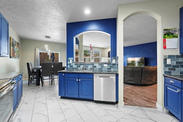 kitchen featuring a sink, stainless steel appliances, a textured ceiling, and marble finish floor