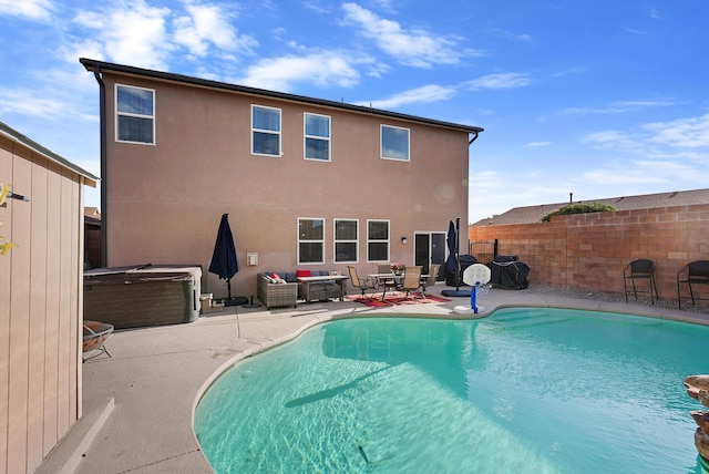 exterior space with fence, a patio, stucco siding, a fenced in pool, and a hot tub