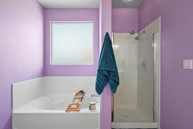 bathroom featuring a garden tub and a stall shower